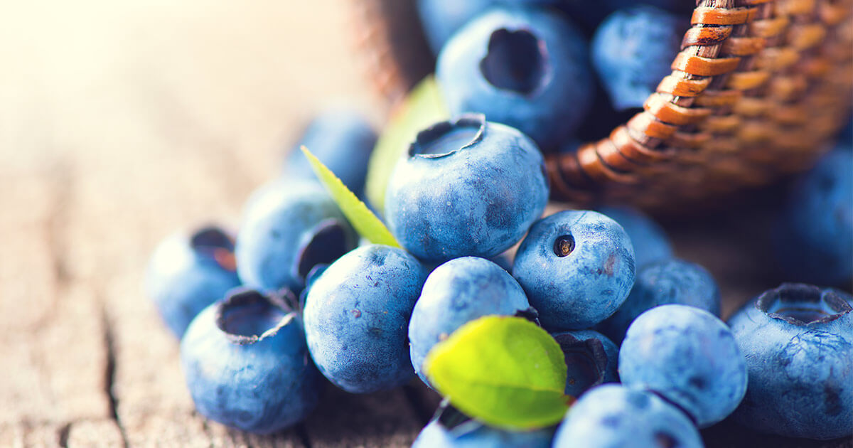 Blueberries Help Lower Blood Pressure Fresh blueberries spilling from a basket